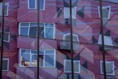 Albania, May 12, 2022 - Reflections of an apartment building in a window.