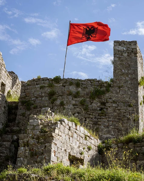 Albania, May 12, 2022 - Albanian flag flies over ruins of Rozafa Castle.