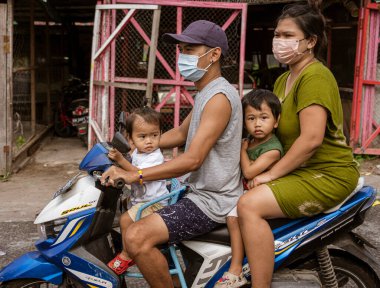 Central Kalamantan, Indonesia, May 20, 2022 - Entire family rides on a single motorcycle.