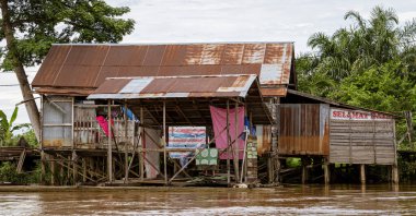 Central Kalamantan, Indonesia, May 20, 2022 - homes seen from the river that are dilapidated and ready to collapse.