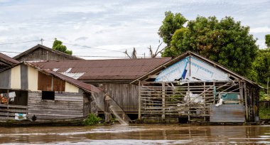 Central Kalamantan, Indonesia, May 20, 2022 - homes seen from the river that are dilapidated and ready to collapse.