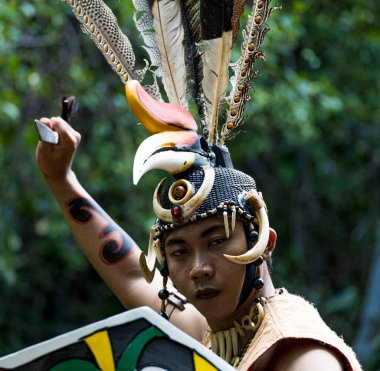 Central Kalamantan, Indonesia, May 20, 2022 - Man poses in traditional indiginous garb or a warrior.