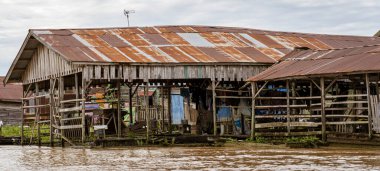 Central Kalamantan, Indonesia, May 20, 2022 - homes seen from the river that are dilapidated and ready to collapse.
