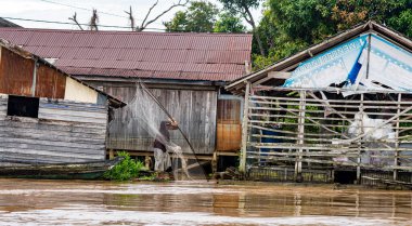Central Kalamantan, Indonesia, May 20, 2022 - homes seen from the river that are dilapidated and ready to collapse.