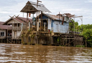Central Kalamantan, Indonesia, May 20, 2022 - homes seen from the river that are dilapidated and ready to collapse.