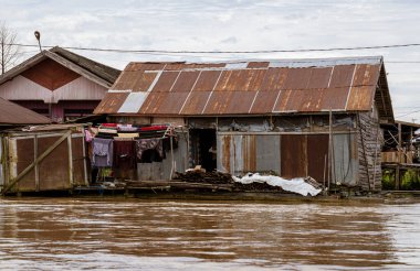 Central Kalamantan, Indonesia, May 20, 2022 - homes seen from the river that are dilapidated and ready to collapse.