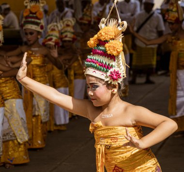 Young girl dances at the temple on Galungan Day in Bali.