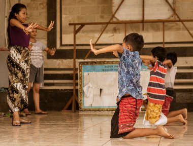 Bali, Indonesia, June 1, 2022 - Young boys learn traditional Bali dances in class.