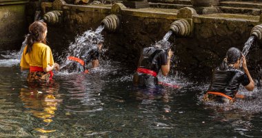 People receive blessing at the Water Temple in Bali aka Tirta Empul temple.