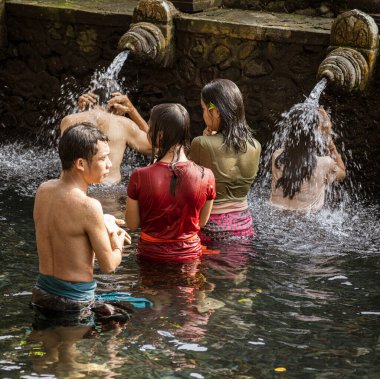 People receive blessing at the Water Temple in Bali aka Tirta Empul temple.