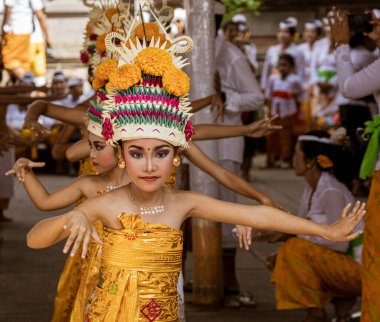 Young girl dances at the temple on Galungan Day in Bali.