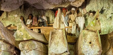 Indonesia, June 13 2022 - Tau Tau wooden effigies in Londa Burial Caves guard the caskets of those dead for hundreds of years.