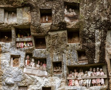 Indonesia, June 13 2022 - Wooden Tau Tau effifies guard tombs in Toraja.