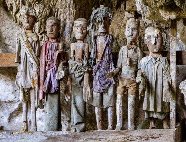Indonesia, June 13 2022 - Tau Tau wooden effigies in Londa Burial Caves guard the caskets of those dead for hundreds of years.