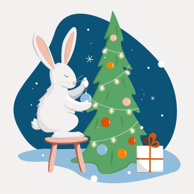  Kış mevsimi. Şirin bir tavşan Noel ağacını süslüyor. Tavşan, hediye kutusu ve Noel ağacı ile Mutlu Noeller. selamlama vektörü çizgi film illüstrasyonu