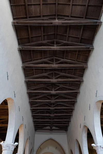 Close-up of the structure of the wooden beams, the trusses, the purlins and the planking. Abruzzo churches. Sulmona