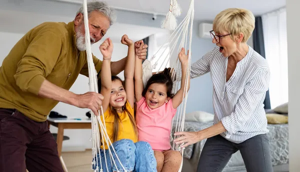 Torunlar eğleniyor, dedelerle evde oynuyorlar. Aile sevgi üretimi konsepti