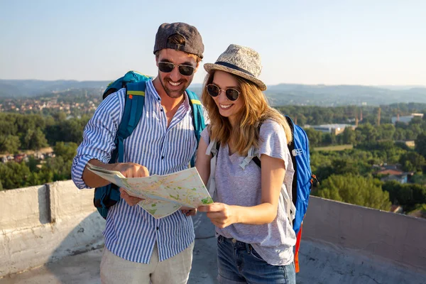 幸せな若い観光客のカップル 地図を持つ友人の観光都市 旅行の人の休暇の概念 — ストック写真