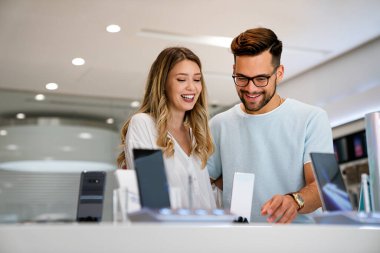 Yeni bir dijital cihaz alıyorum. Mutlu çift mağazadan bir cep telefonu alıyor..