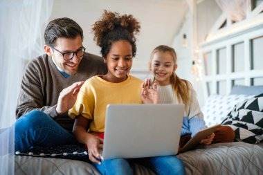 Tablette oynayan mutlu çoklu etnik çocukların ve babaların portresi. Teknoloji ailesi yaşam tarzı kavramı