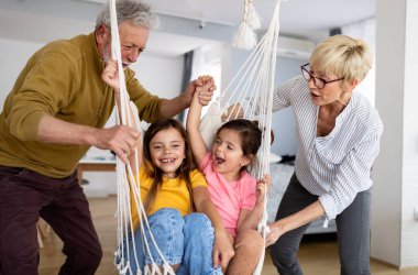 Torunlar eğleniyor, dedelerle evde oynuyorlar. Aile sevgi üretimi konsepti