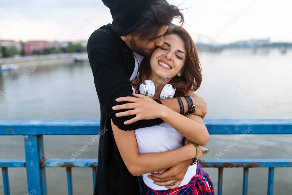 Portrait of happy young couple in love enjoying time together in city. People travel fun happiness concept