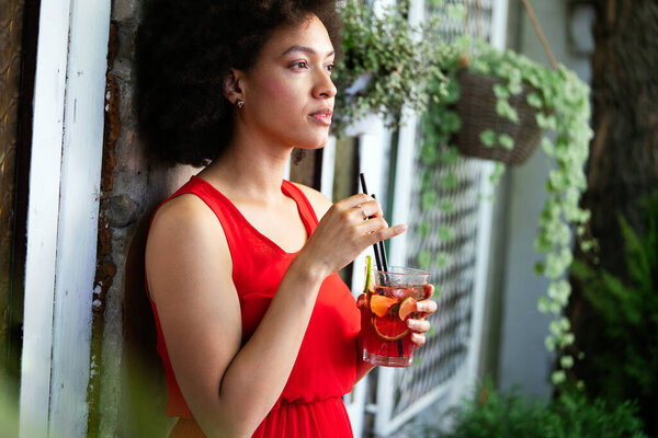 Young african woman enjoy healthy vegetarian smoothie for weight loss and detox