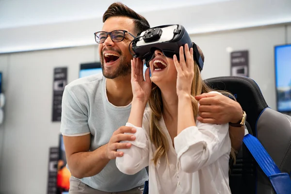 Group of young people using virtual reality headset at exhibition, show. VR technology simulation concept