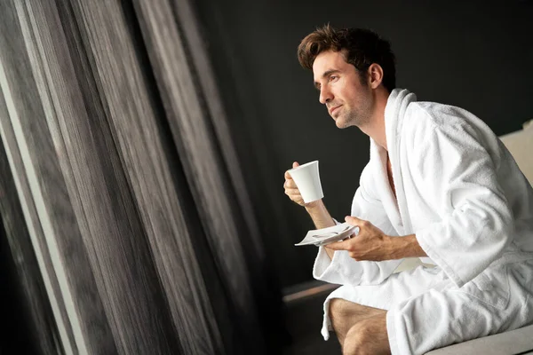 ハンサムで筋肉質で若い男が家で朝のコーヒーを飲んで — ストック写真