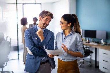 Çok ırklı başarılı iş adamlarından oluşan bir grup ofiste toplanıyor ve fikirlerini paylaşıyor..