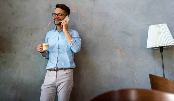 Portrait Smiling Young Handsome Business Man Using Smartphone Holding Cup — Foto de Stock