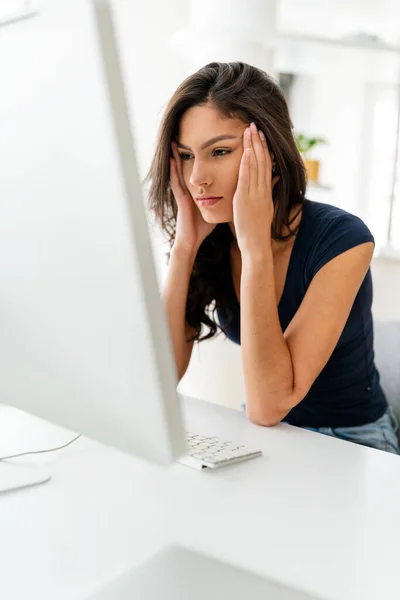 Young beautiful woman tired from work on computer. Technology, people concept