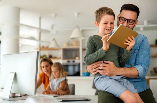 Digital device technology family online education concept. Happy young family with digital devices at home.