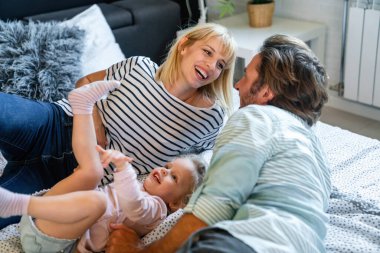 Mutlu genç aile evde eğleniyor. İnsanlar çocuk yuvası kavramını sever.
