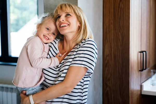 Young single mother concept. Happy mother with her little girl spendig time together at home.