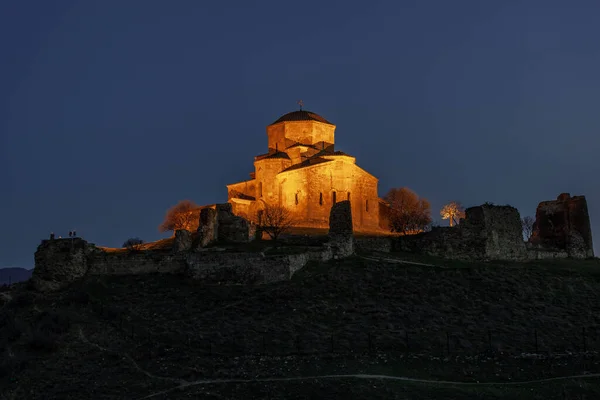 stock image Illuminated Jvari Monastery on the top of the hill at night. Mtskheta, Georgia