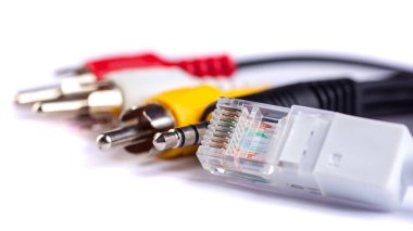 Electric plug of television and audio-video power supply on white backgrund. RGB and lan cable