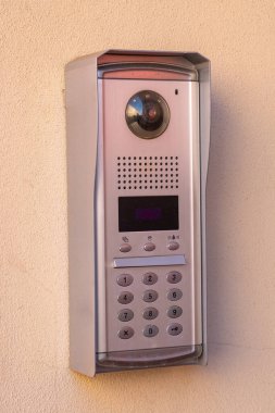 Intercom doorbell and access code panel on wall of residential building