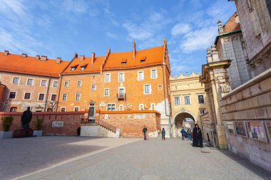 Krakow, Poland - 14 March, 2022: Tourists walking inside the Wawel Castle yard. Travel