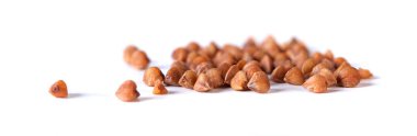 Pile of buckwheat seeds isolated on white background, closeup. Food