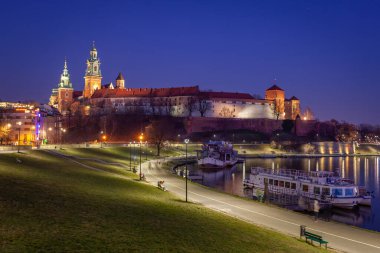 Krakow, Poland, Wawel Castle and Wawel cathedral over Vistula river in the night. Travel