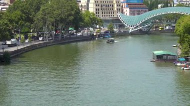 Tbilisi, Georgia - 23 August, 2022: Pleasure tourist boats on the river Mtkvari in the city of Tbilisi