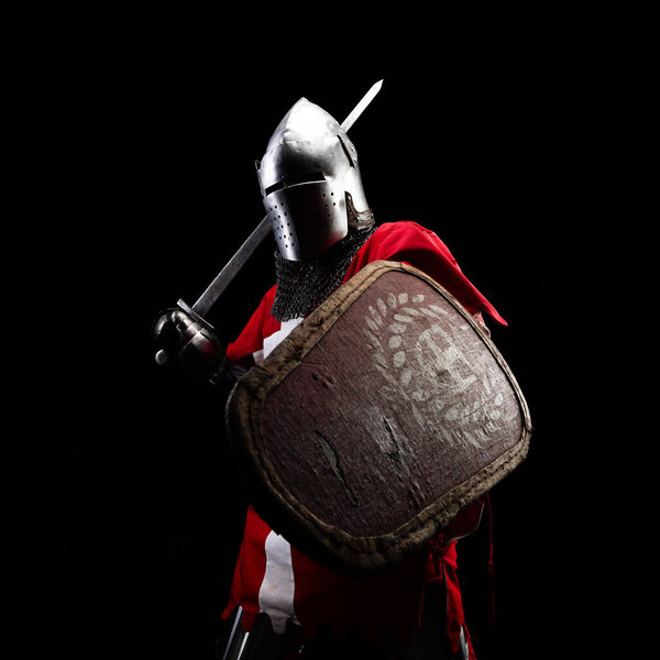 Knight with sword and red checkered shield.