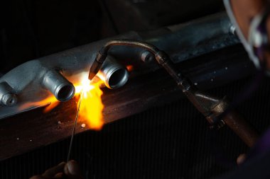 flame of welding steel spark in the dark by technician