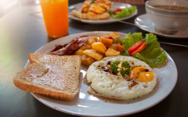 fresh American breakfast on white plate on gray table