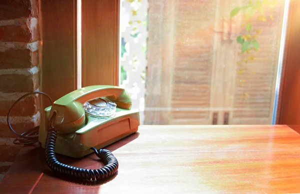vintage home telephone on table by window in the morning