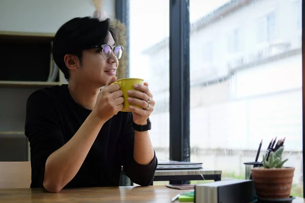 Thoughtful Young Asian Man Holding Cup Coffee Looking Out Window — Stock Photo, Image