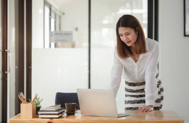 Businesswoman analysing business data on computer.	