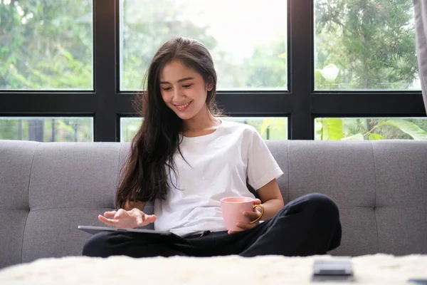 Smiling Asian Woman Sitting Living Room Using Digital Tablet — Φωτογραφία Αρχείου
