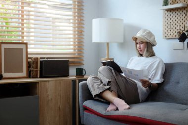 A young female administrative assistant making notes of working planning organizing information in her home.	